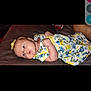 Bailey is registered to the contest to win money with this photo: baby, infant, child, girl, lying_down, floral_dress, butterflies, yellow_bow, cushion, fabric, cute, portrait, indoors, holding, clothing, skin, head, hand, small_child, relaxing