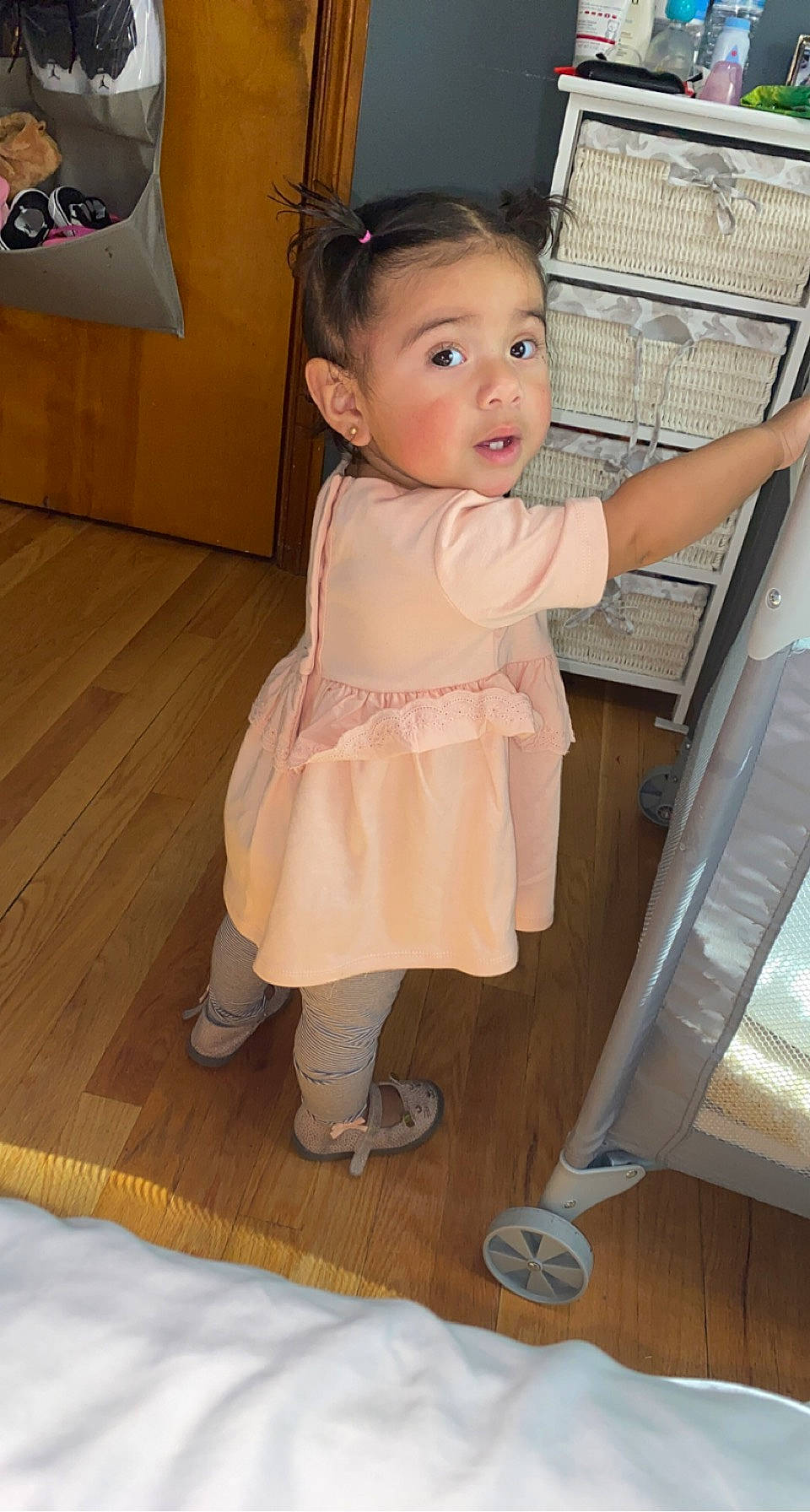 Alyssa joined the competition — help win amazing prizes! baby, baby_products, baby_toddler_clothing, cheek, child, floor, flooring, hardwood, human_leg, pattern, person, room, sitting, skin, sleeve, sock, stairs, surprise, toddler, white