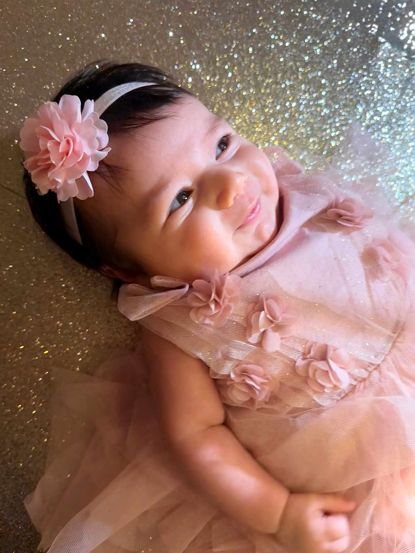 Scarlett joined the competition — help win amazing prizes! baby, infant, girl, pink_dress, headband, flower, smile, sparkle, glitter, happy, portrait, cute, child, tulle, fabric, skin, closeup, lying_down, soft_lighting, adorable