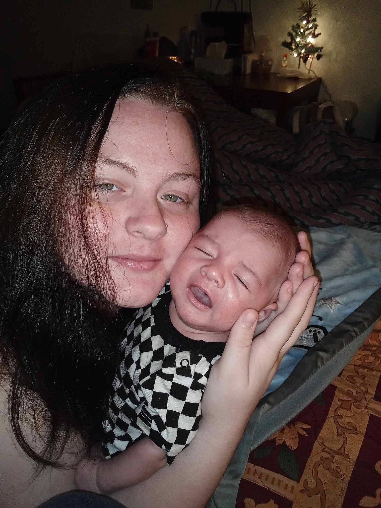 Raven is registered to the contest to win money with this photo: baby, cheek, child, comfort, darkness, event, face, flash_photography, fun, gesture, happy, hug, iris, lamp, mouth, nose, person, sitting, skin, smile