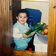 Bıdıskom joined the competition — help win amazing prizes! apple, baby, bottle, cabinet, child, clothing, container, curious, door, fruit, happy, household, indoor, kitchen, person, plastic_bowl, sitting, smile, toddler, wood