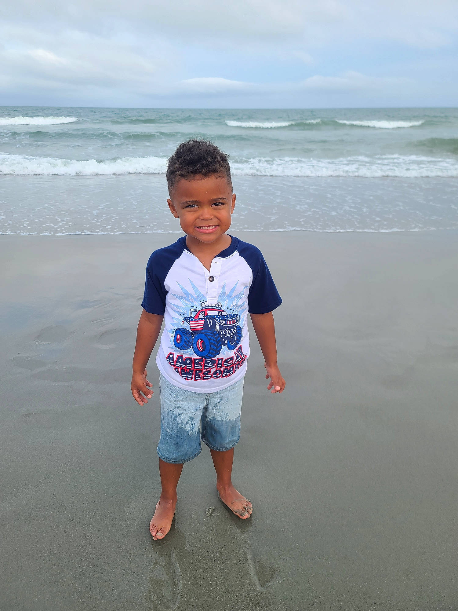 Kendrick joined the competition — help win amazing prizes! azure, beach, child, cloud, coastal_and_oceanic_landforms, fun, happy, horizon, joy, leisure, natural_environment, people_on_beach, person, sand, sky, sleeve, smile, standing, t_shirt, travel