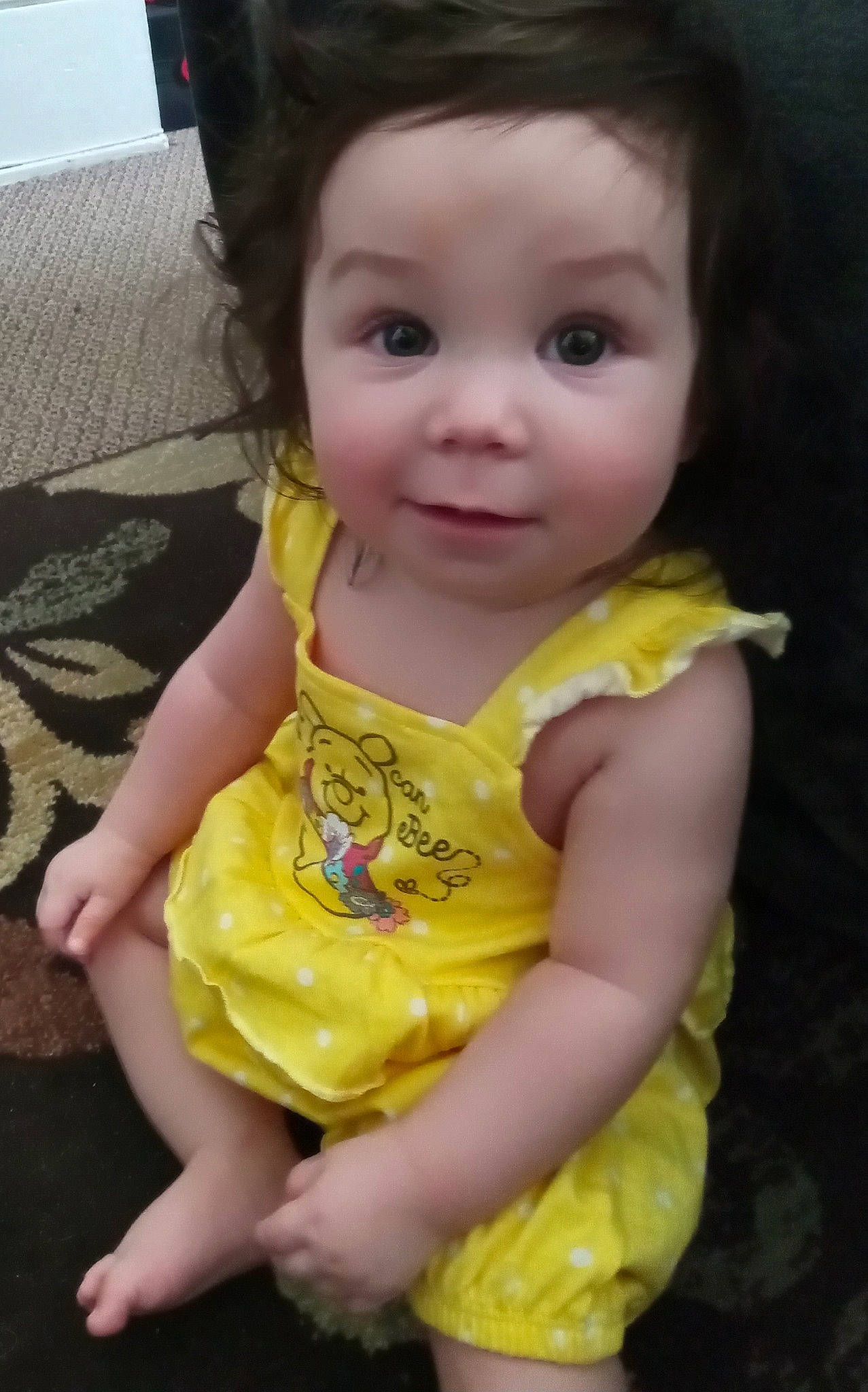 Arielle is registered to the contest to win money with this photo: baby, baby_toddler_clothing, cheek, child, chin, dress, eye, eyelash, face, fun, happy, head, iris, lip, nose, person, sitting, skin, sleeve, toddler