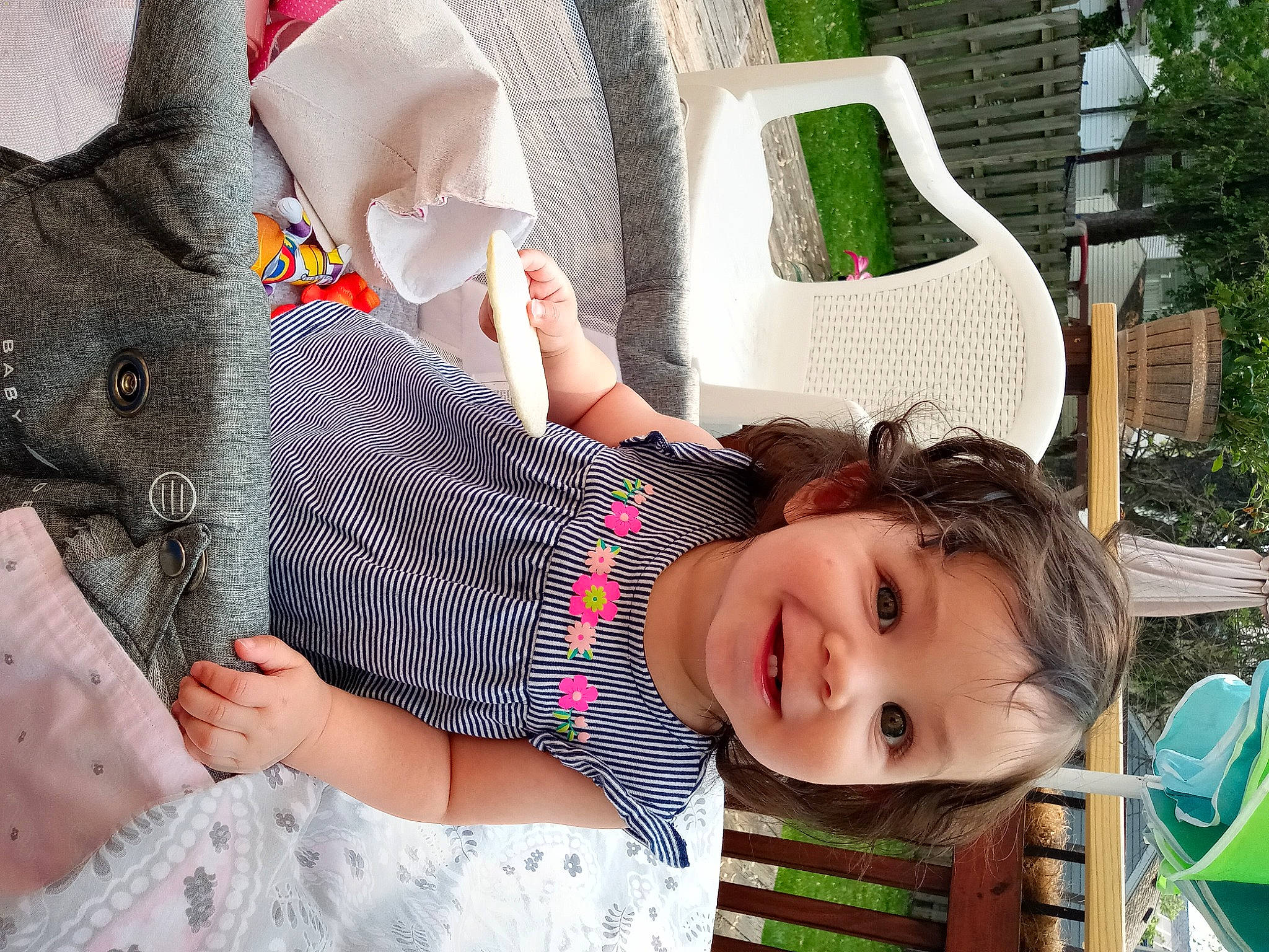 Arielle is registered to the contest to win money with this photo: baby_toddler_clothing, beauty, child, comfort, facial_expression, grass, green, hairstyle, happy, joy, leaf, leisure, outdoor_furniture, pattern, person, photograph, plant, skin, smile, snapshot