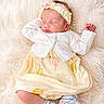 baby, newborn, sleeping, headband, dress, socks, soft_texture, fluffy, infant, cute, peaceful, resting, clothing, portrait, indoors, child, adorable, cozy, skin, hand
