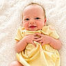 baby, infant, yellow_dress, smile, hands, blue_eyes, soft_blanket, cute, newborn, lying_down, happy, skin, portrait, child, young, adorable, cozy, fuzzy_background, peaceful, small_fingers