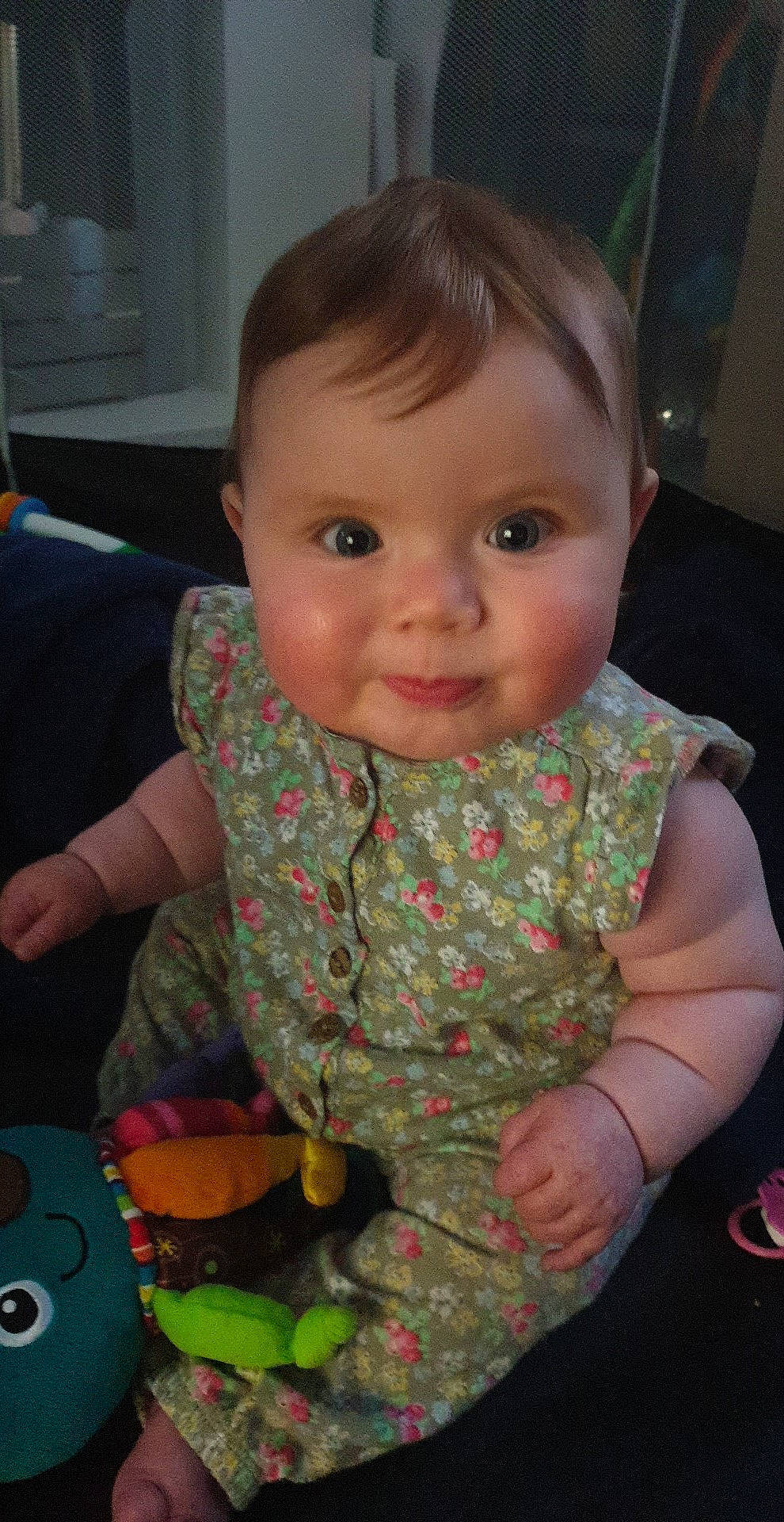 Elora joined the competition — help win amazing prizes! baby, baby_products, baby_toddler_clothing, cheek, child, facial_expression, finger, flooring, fun, green, head, iris, lip, mouth, nose, person, sitting, skin, smile, toddler