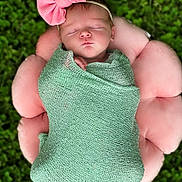 Rory is registered to the contest to win money with this photo: baby, blanket, cap, clothing, dress, face, flower, glove, grass, hat, head, newborn, person, petal, photography, plant, portrait, rose, sleeping, towel