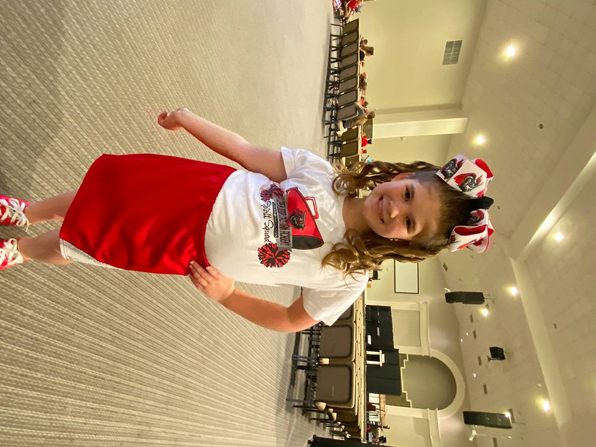 Emma is registered to the contest to win money with this photo: carmine, costume, elbow, entertainment, event, fashion_design, flooring, fun, happy, human_leg, joy, performing_arts, person, room, smile, thigh, window