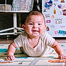 baby, smiling, play_mat, indoor, child, face, happy, crawling, furniture, chair, fridge, stickers, floor, home, person, cute, infant, clothing, skin, expression