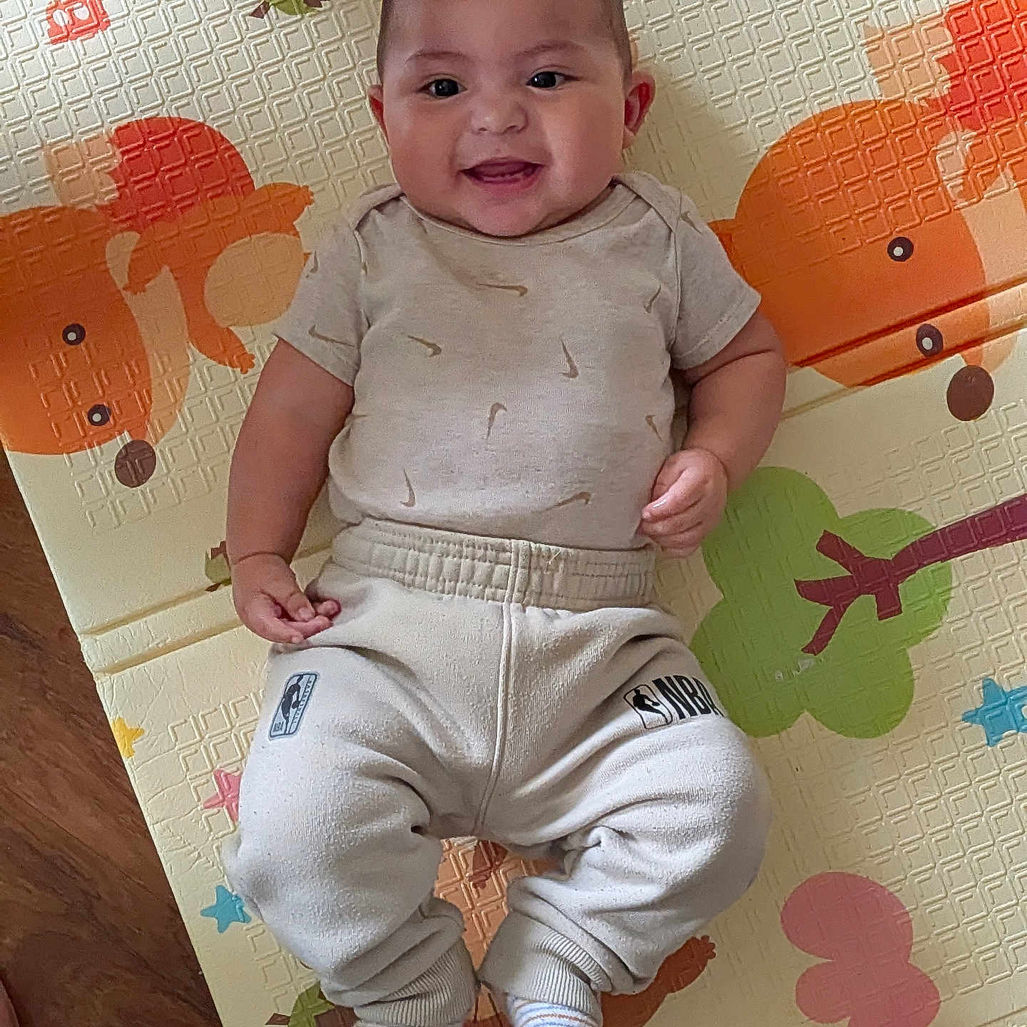 Prosper is registered to the contest to win money with this photo: baby, child, smiling, play_mat, colorful, animal_print, infant, clothing, socks, floor, wooden_floor, cute, happy, person, indoors, portrait, young_child, feet, hand, casual_wear