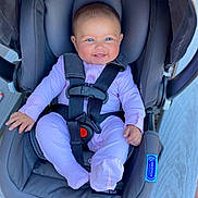 Zanaiah is registered to the contest to win money with this photo: baby, infant, car_seat, graco, child, smiling, blue_eyes, pink_onesie, seatbelt, safety_harness, cute, happy, strapped_in, indoor, person, small_hands, footed_pajamas, headrest, baby_gear, child_safety