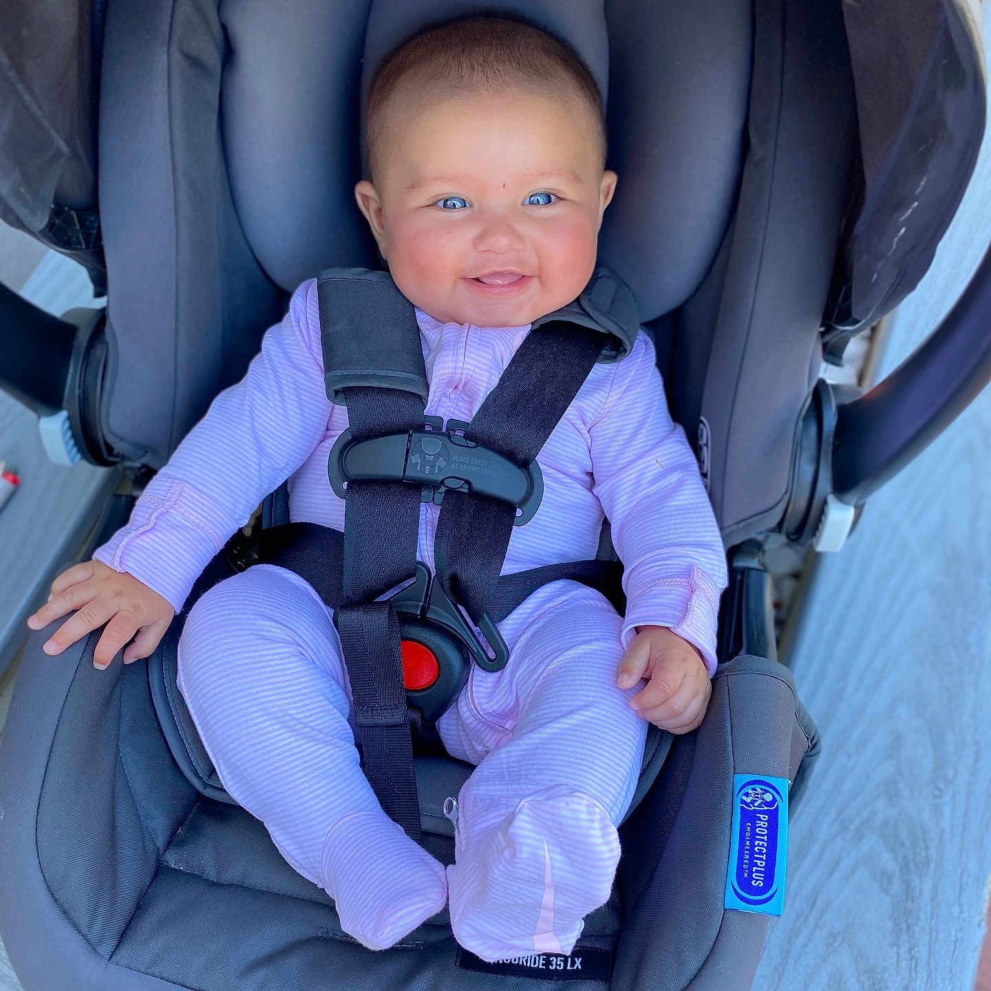 Zanaiah is registered to the contest to win money with this photo: baby, baby_gear, blue_eyes, car_seat, child, child_safety, cute, footed_pajamas, graco, happy, headrest, indoor, infant, person, pink_onesie, safety_harness, seatbelt, small_hands, smiling, strapped_in