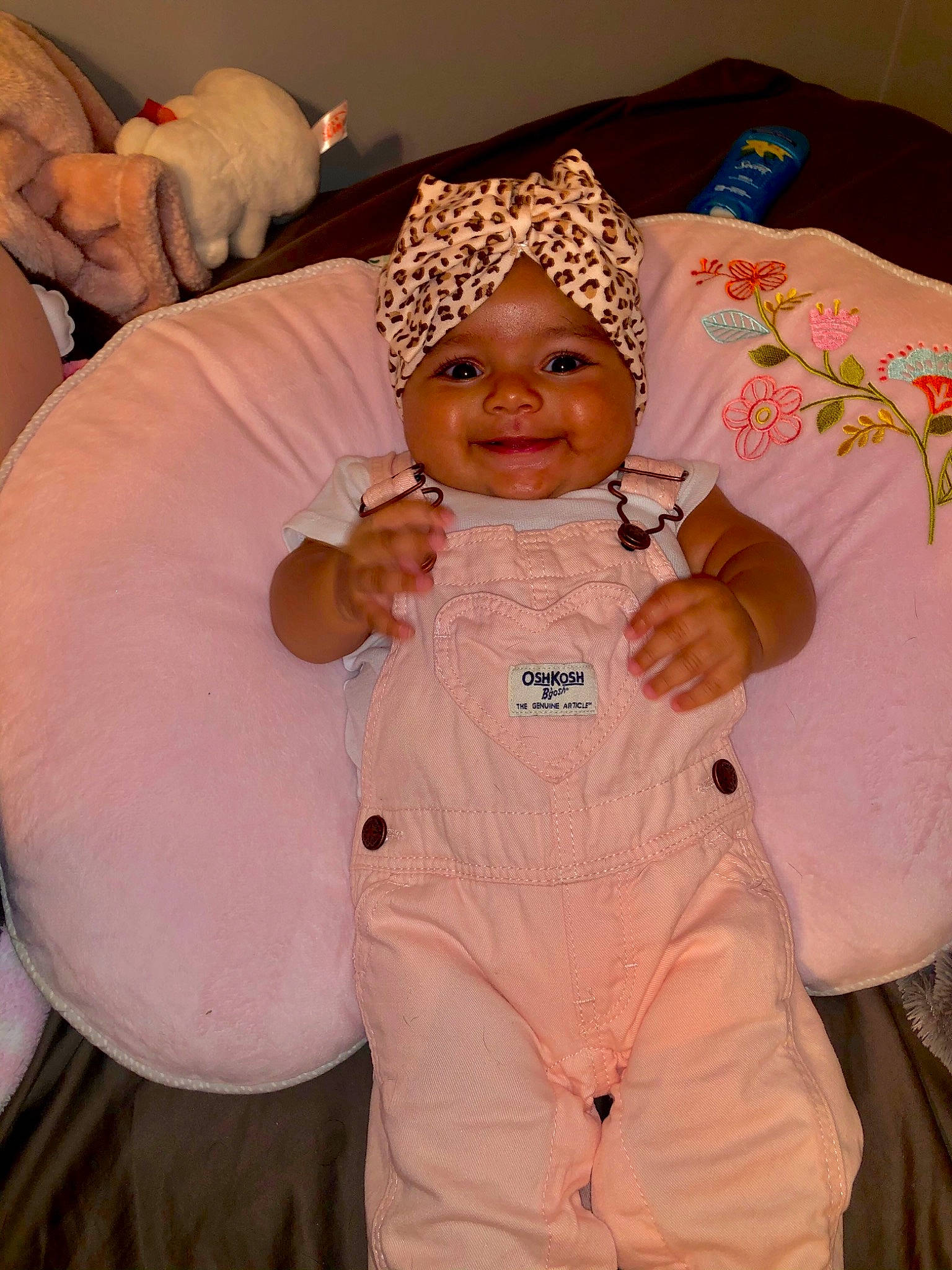 Lyanna is registered to the contest to win money with this photo: baby, child, event, finger, fun, gesture, glove, happy, headwear, joy, orange, peach, person, pink, room, sleeve, smile, textile, thumb, toddler