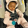 baby, infant, child, car_seat, sleeping, harness, seatbelt, pacifier, pink_bunting, hood_with_ears, plush_texture, closed_eyes, peaceful, shiny_lips, mittens, black_straps, safety_label, fabric, indoors, portrait