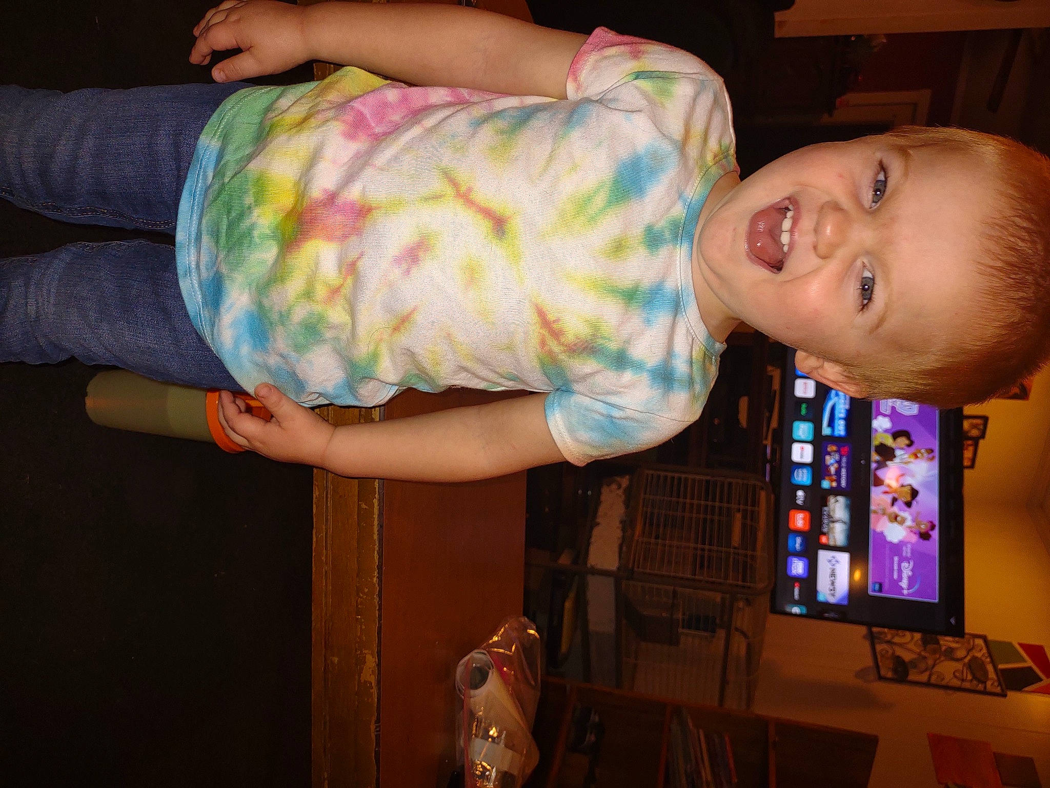 Daniel is registered to the contest to win money with this photo: abdomen, baby, baby_toddler_clothing, child, elbow, finger, fun, happy, human_leg, mouth, pattern, person, room, sitting, smile, t_shirt, thigh, toddler