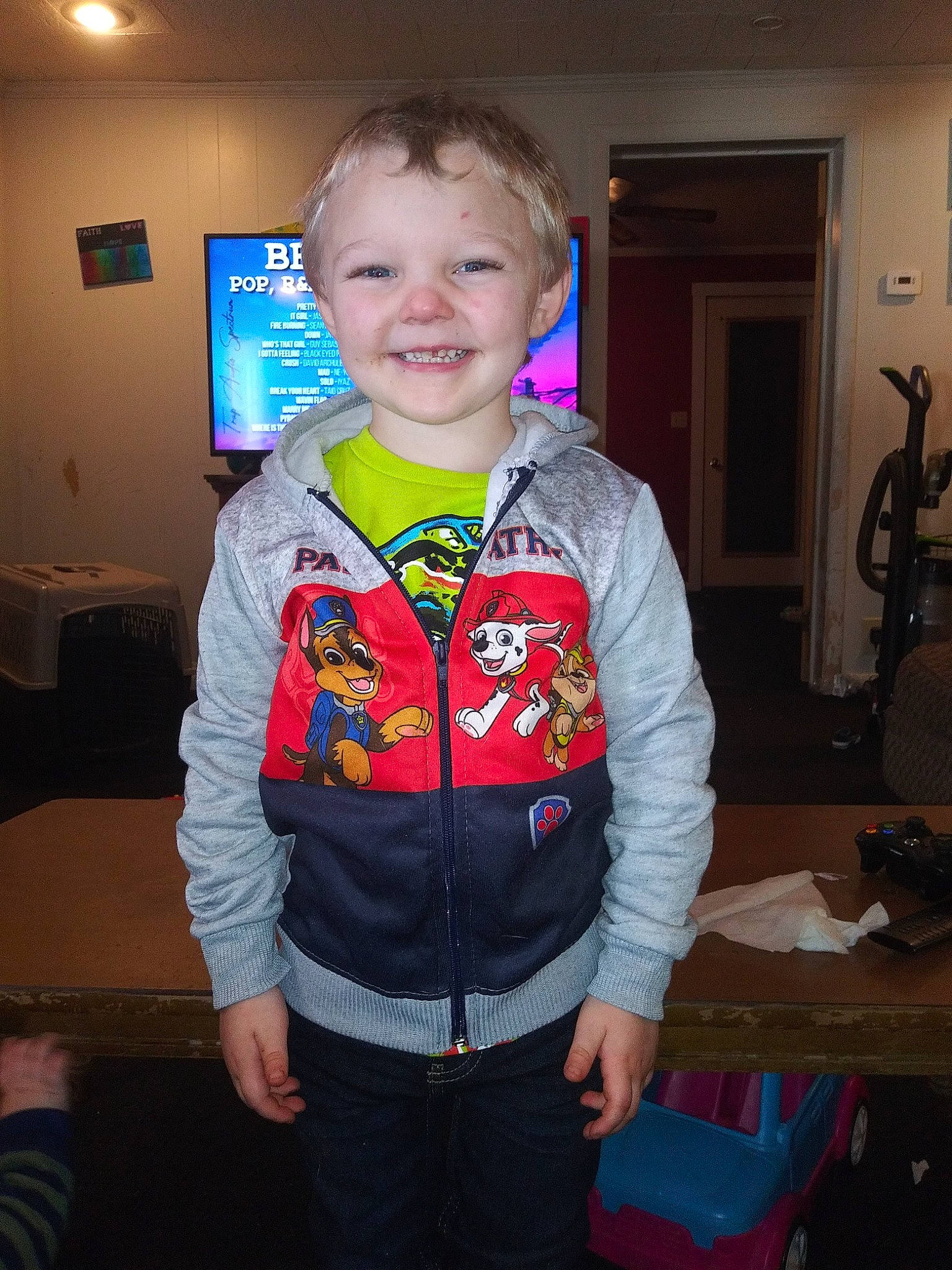 Liam is registered to the contest to win money with this photo: baby_toddler_clothing, cheek, child, costume, electric_blue, event, fun, happy, iris, jeans, joy, party, person, personal_protective_equipment, picture_frame, room, sitting, sleeve, smile, standing