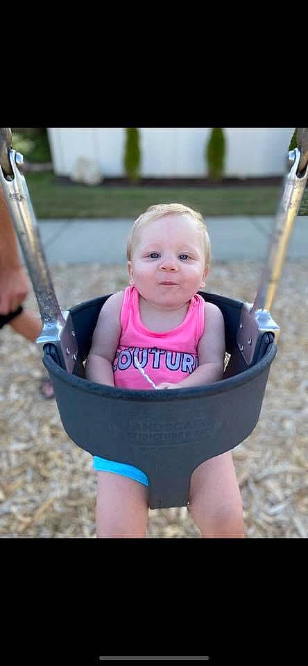 Amiliana is registered to the contest to win money with this photo: baby, baby_carriage, baby_products, child, fun, outdoor_play_equipment, person, play, playground, product, public_space, recreation, smile, swing, toddler