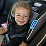 toddler, child, car_seat, graco, smiling, seat_belt, black_shirt, curly_hair, safety, car_interior, happy, portrait, young_child, baby, seatbelt_buckle, closeup, cute, child_safety, kid, travel