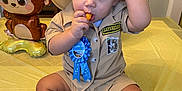 Malekhi is registered to the contest to win money with this photo: baby, bodypart, clothing, costume, cream, dessert, face, finger, food, hand, hat, head, hosiery, icecream, person, photography, portrait, shorts, sitting, sock