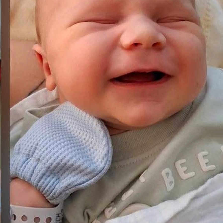Sammuel joined the competition — help win amazing prizes! baby, bed, blanket, close_up, clothing, cute, face, happy, hospital_bracelet, indoor, infant, knitwear, mitten, newborn, onesie, photograph, portrait, screen_capture, sleeping, smiling