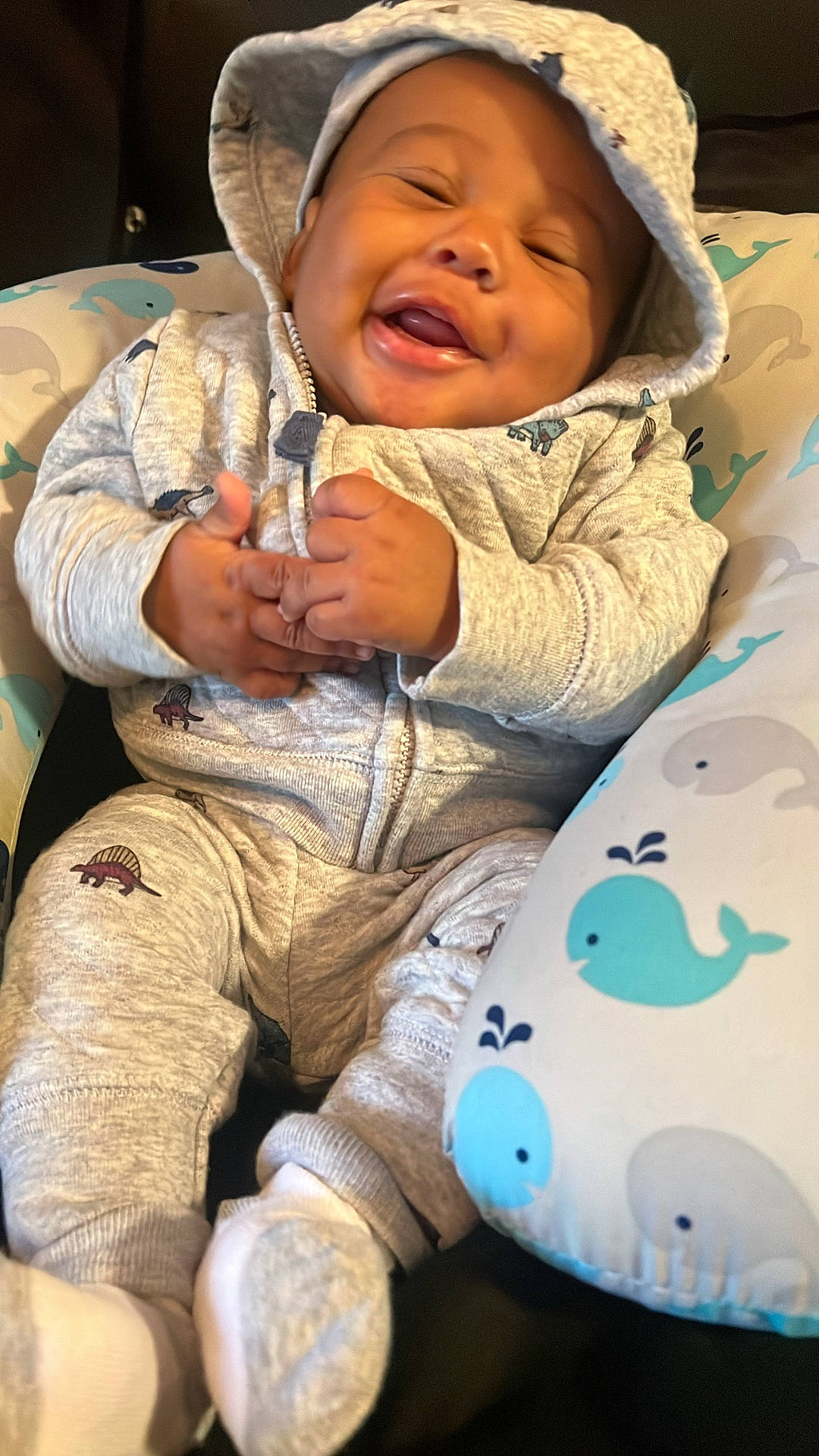 Kamden is registered to the contest to win money with this photo: baby, babylaughing, bodypart, bonnet, cap, clothing, coat, face, finger, hand, happy, hat, head, hoodie, jacket, knitwear, person, photography, portrait, sweater