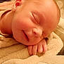 baby, newborn, sleeping, blanket, hand, cozy, soft, smile, infant, face, skin, peaceful, closeup, warm, knitted, cuddle, child, resting, indoors, portrait