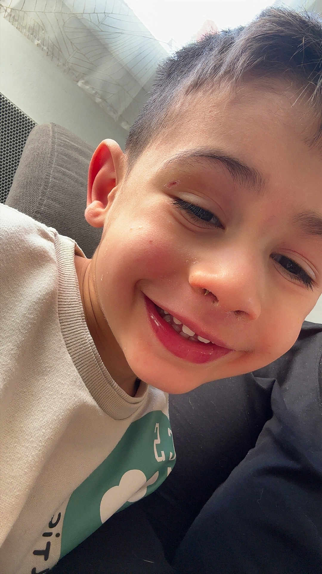 Thomas a rejoint le concours — aidez-le/la à gagner de superbes lots ! child, boy, smiling, face, indoor, couch, curtain, window, shirt, short_hair, happy, closeup, skin, eye, nose, mouth, ear, casual, portrait, natural_light