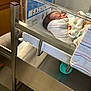 Jermaine is registered to the contest to win money with this photo: animal_prints, baby, bassinet, bed, blanket, crib, cute, hospital, indoor, infant, medical, name_tag, newborn, peaceful, person, plastic, resting, sleeping, striped_blanket, wrapped