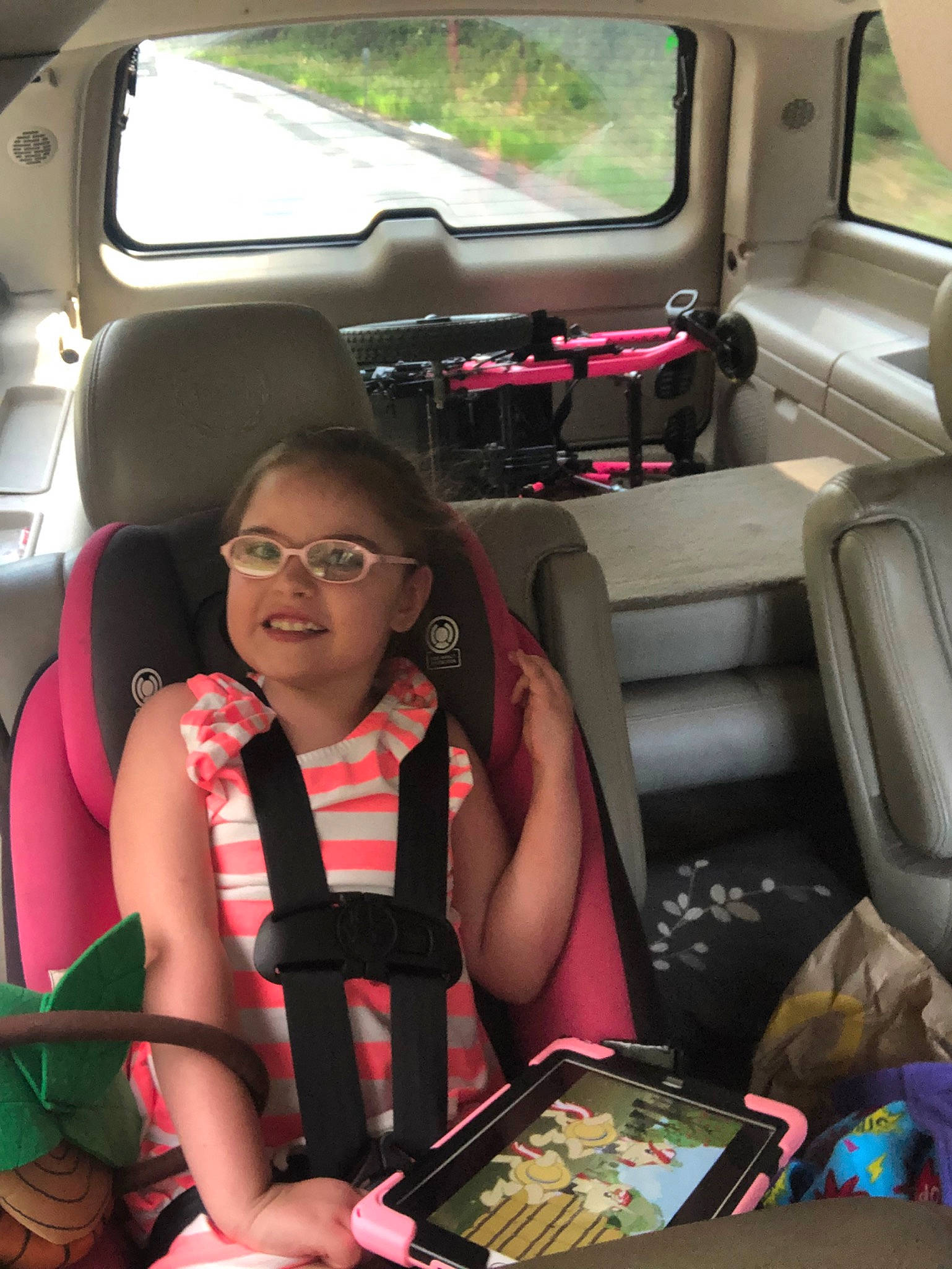 Michaela is registered to the contest to win money with this photo: car, car_seat, car_seat_cover, family_car, glasses, head_restraint, joy, passenger, person, vacation, vehicle