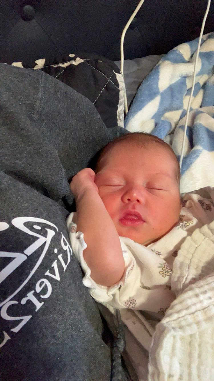 Ellie is registered to the contest to win money with this photo: newborn, baby, sleeping, blanket, person, hoodie, face, hand, cozy, resting, closeup, indoor, soft, peaceful, infant, clothing, bed, comfort, child, portrait