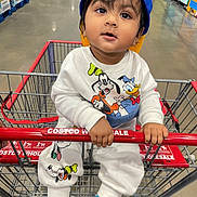 Veer is registered to the contest to win money with this photo: aisle, blue_cap, cap, child, costco, curious_expression, disney_characters, donald_duck, floor, goofy, handrail, indoor, mickey_mouse, person, shopping_cart, socks, store, toddler, warehouse, white_outfit
