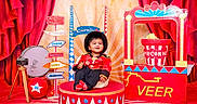 Veer joined the competition — help win amazing prizes! camera, carnival, child, circus, colorful, costume, drum, festive, hat, indoor, platform, playful, popcorn, portrait, props, red_curtains, signpost, smiling, studio, toddler