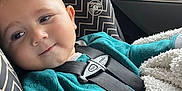 James joined the competition — help win amazing prizes! baby, child, car_seat, seatbelt, teal_clothing, blanket, car_interior, window, autumn, fall_colors, smile, face, head, person, young_child, safety, cute, indoor, soft_texture, cozy