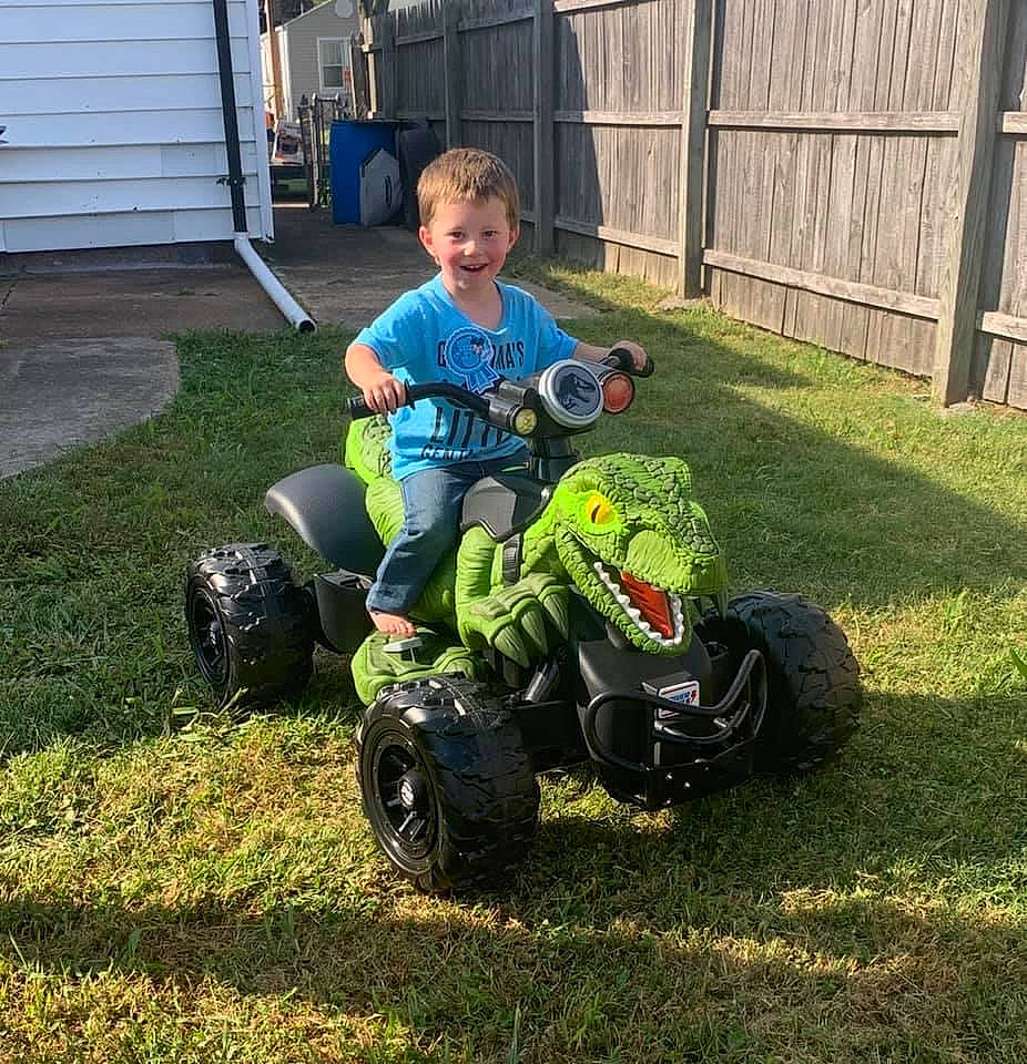 Dennis joined the competition — help win amazing prizes! all_terrain_vehicle, auto_part, backyard, driveway, fence, garden, grass, home_fencing, joy, lawn, person, play, riding_toy, rolling, siding, synthetic_rubber, tire_care, toddler, toy, toy_vehicle