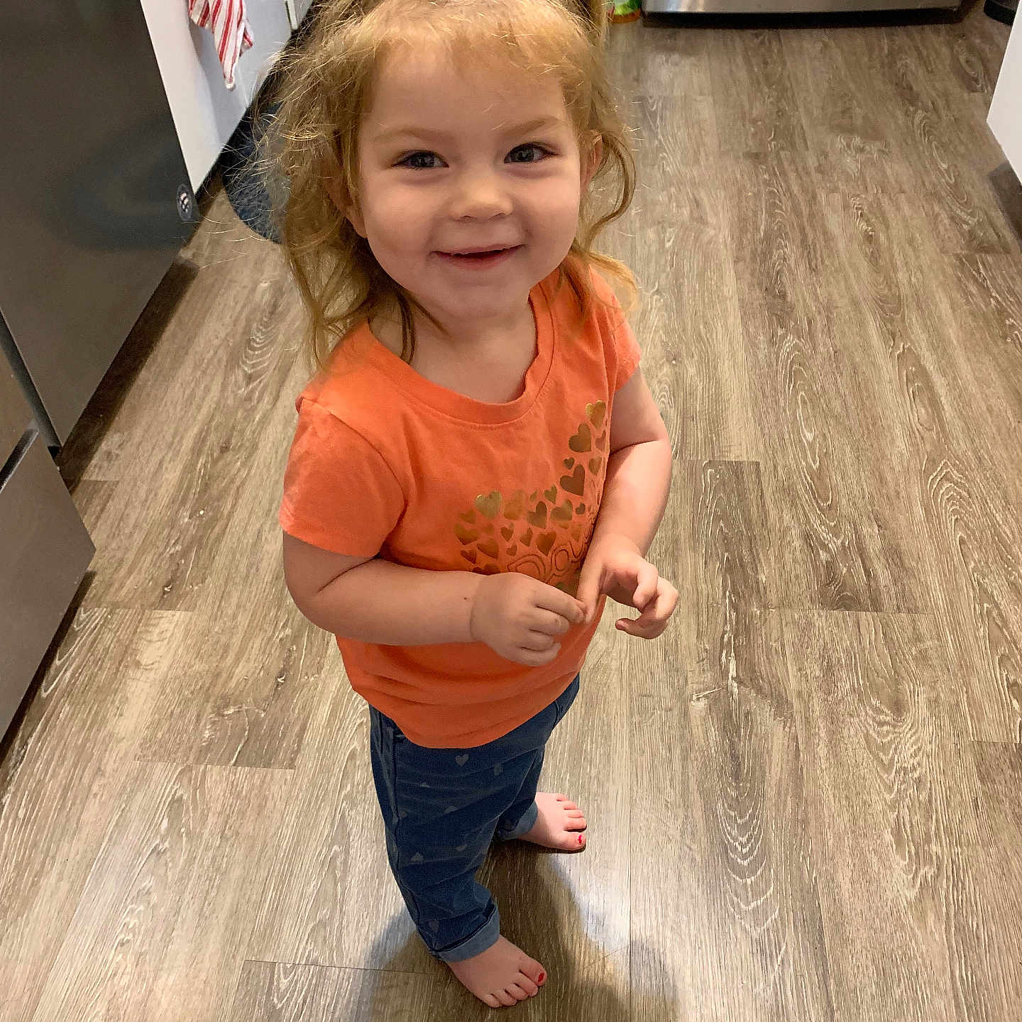 Alyvia is registered to the contest to win money with this photo: blonde, child, clothing, face, female, girl, glove, hair, happy, hardwood, head, indoors, interiordesign, jeans, pants, person, photography, portrait, standing, wood