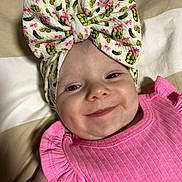 Gracie joined the competition — help win amazing prizes! baby, smile, headband, bow, pink_clothing, infant, face, child, cute, apparel, blanket, pattern, portrait, happy, ruffle, fabric, skin, closeup, laying, indoors