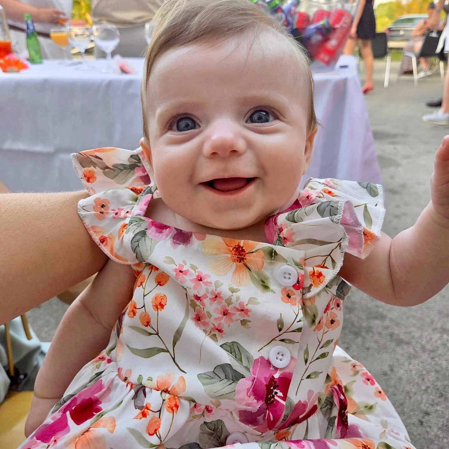 Léa participe au concours pour gagner de l'argent avec cette photo : baby, blue_eyes, bottle, celebration, child, colorful, cute, event, floral_dress, glassware, happy, outdoor, party, people, person, portrait, sitting, smiling, summer, table