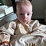 Mayer is registered to the contest to win money with this photo: baby, child, messy, food, bib, high_chair, indoor, portrait, face, curious, feeding, infant, clothing, expression, cute, young, sitting, meal_time, dining, smudged