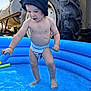 toddler, child, diaper, blue_pool, pool_noodle, water, hat, outdoor, tractor_tire, farm, summer, play, barefoot, sunlight, young_child, cute, fun, splash, blue, small_pool