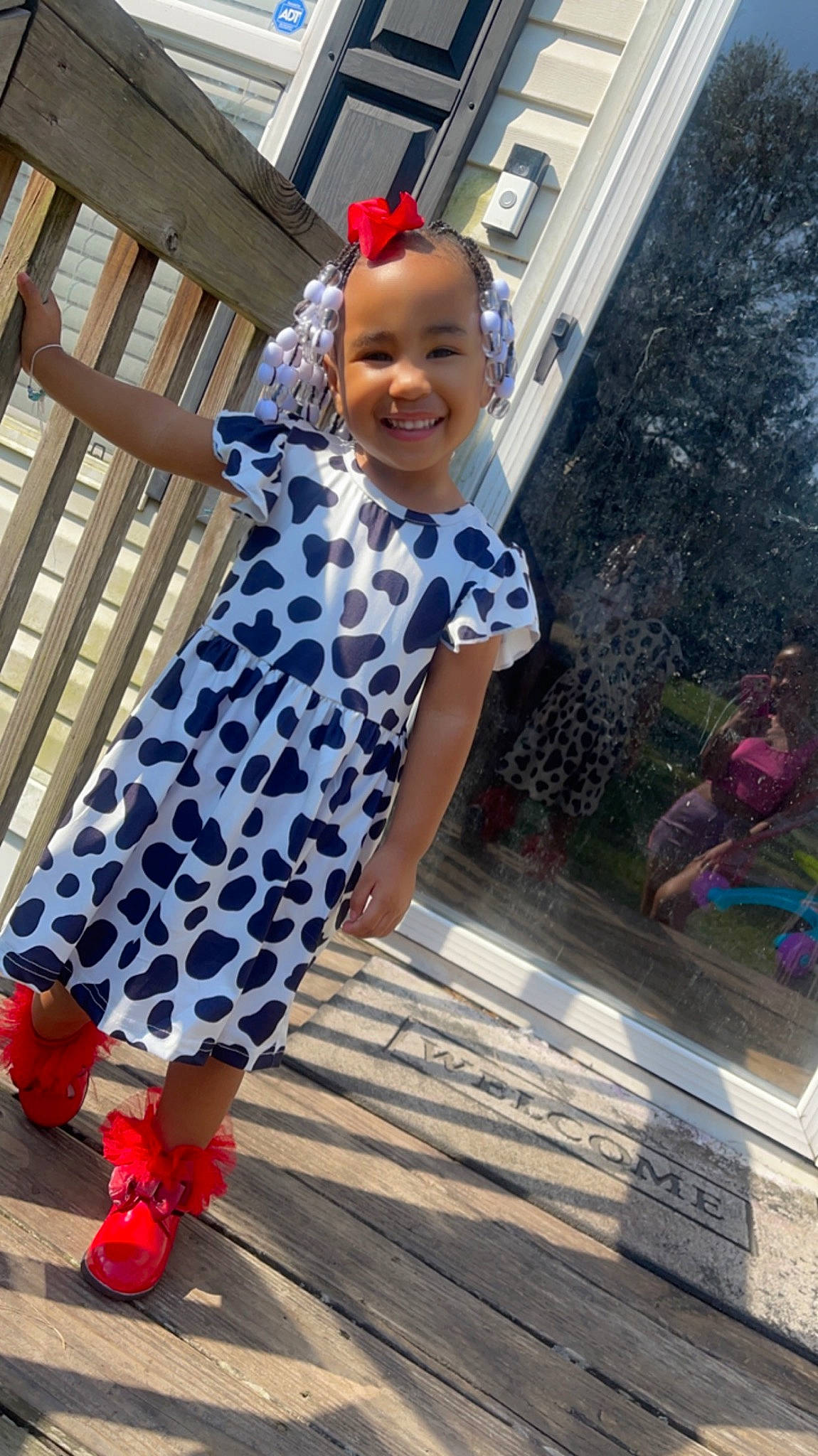 Milani is registered to the contest to win money with this photo: child, electric_blue, flooring, fun, happy, human_leg, joy, leisure, magenta, pattern, person, plaid, plant, sandal, sleeve, smile, tartan, toddler, tradition, vacation