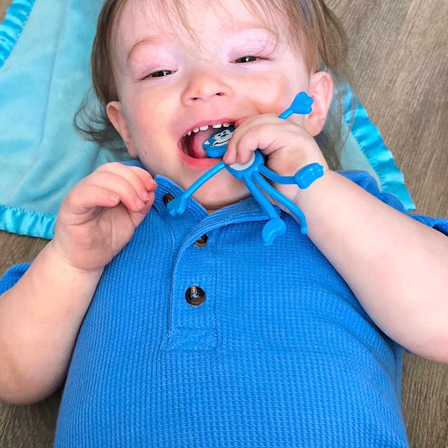 Kayn joined the competition — help win amazing prizes! toddler, child, blue_clothing, smiling, toy, blanket, floor, happy, baby, person, cute, playful, indoor, infant, head, face, hand, skin, young_child, casual