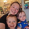Kayn is registered to the contest to win money with this photo: boy, casual, ceiling_fan, child, clothing, face, family, hair, happy, holding, home, indoor, kitchen, light, person, portrait, shelf, smile, toddler, woman
