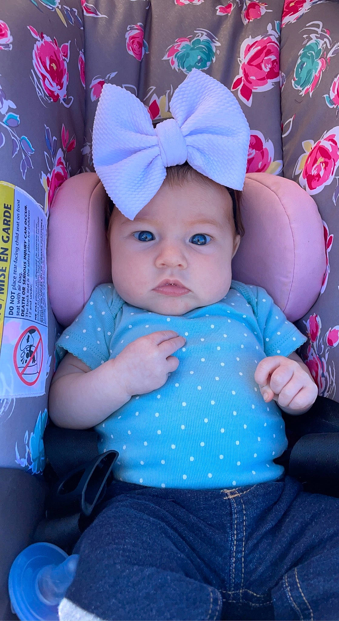 Melanie is registered to the contest to win money with this photo: arm, baby, baby_toddler_clothing, baseball_cap, blue, cap, clothing, eye, facial_expression, hand, happy, hat, head, headwear, person, pink, skin, sleeve, textile, toddler