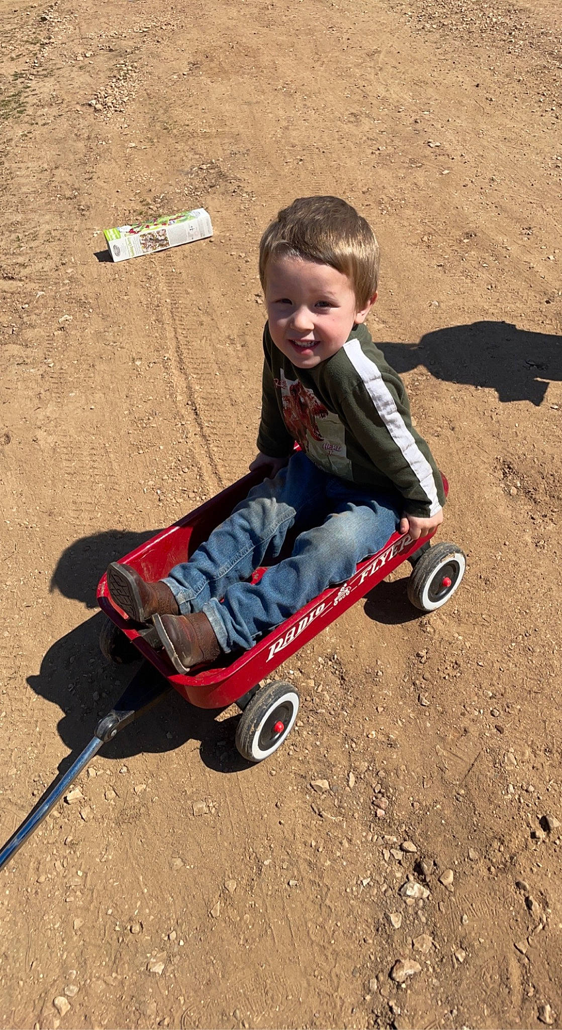Augustus is registered to the contest to win money with this photo: child, electric_blue, fun, happy, joy, person, play, recreation, rolling, sand, shadow, sitting, smile, soil, tire, toddler, wheel