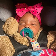 Promise is registered to the contest to win money with this photo: baby, sleeping, pacifier, pink_bow, car_seat, blanket, teddy_bear_jacket, child, infant, cozy, cute, headband, straps, seatbelt, indoors, closeup, peaceful, adorable, warm, resting