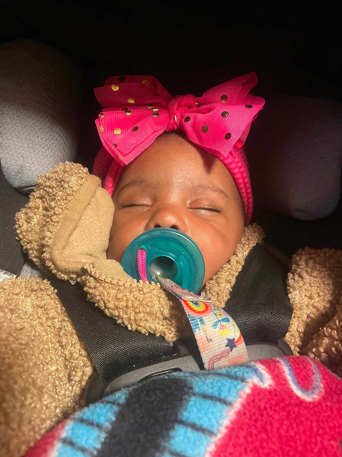 Promise is registered to the contest to win money with this photo: baby, sleeping, pacifier, pink_bow, car_seat, blanket, teddy_bear_jacket, child, infant, cozy, cute, headband, straps, seatbelt, indoors, closeup, peaceful, adorable, warm, resting