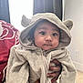 Mercellus Hendson is registered to the contest to win money with this photo: baby, child, hoodie, cozy_clothing, fuzzy, ears, face, hands, indoor, portrait, curious, wide_eyes, chubby_cheeks, person, soft_lighting, window, carpet, neutral_wall, cute, warm