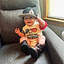 baby, child, cap, hat, shirt, boots, armchair, smile, indoor, window, light, happy, clothing, person, infant, furniture, legs, hand, sitting, cute