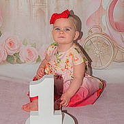 Bonnie-Rae is registered to the contest to win money with this photo: baby, child, girl, birthday, number_one, headband, red_bow, dress, floral, blue_eyes, fairy_tale, castle, carriage, roses, pink, celebration, portrait, sitting, indoor, cute